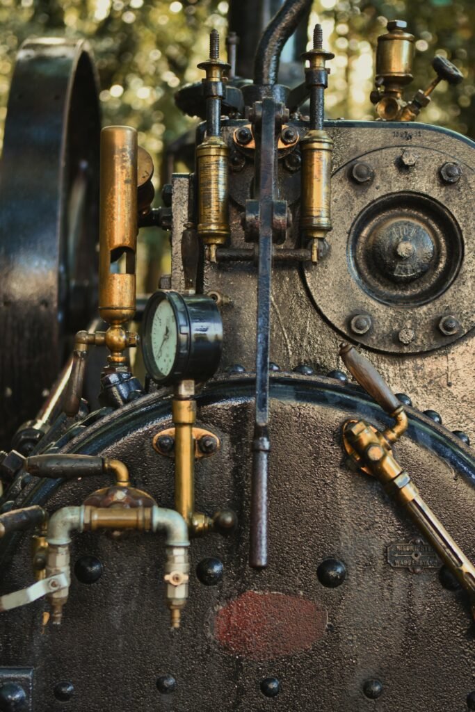 aerospace Close-up view of antique steam engine machinery with brass pipes.