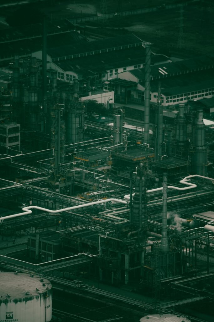 automotive Drone shot of a large industrial power plant with pipes and machinery at dusk.