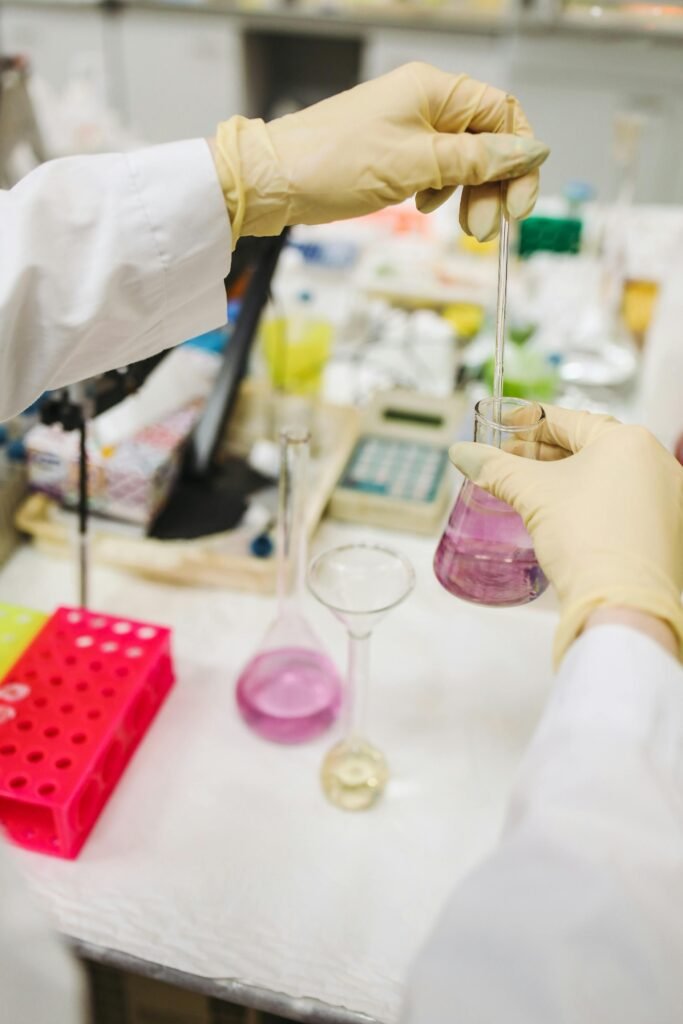 Products Scientist pouring chemicals for research experiment in a lab setting.